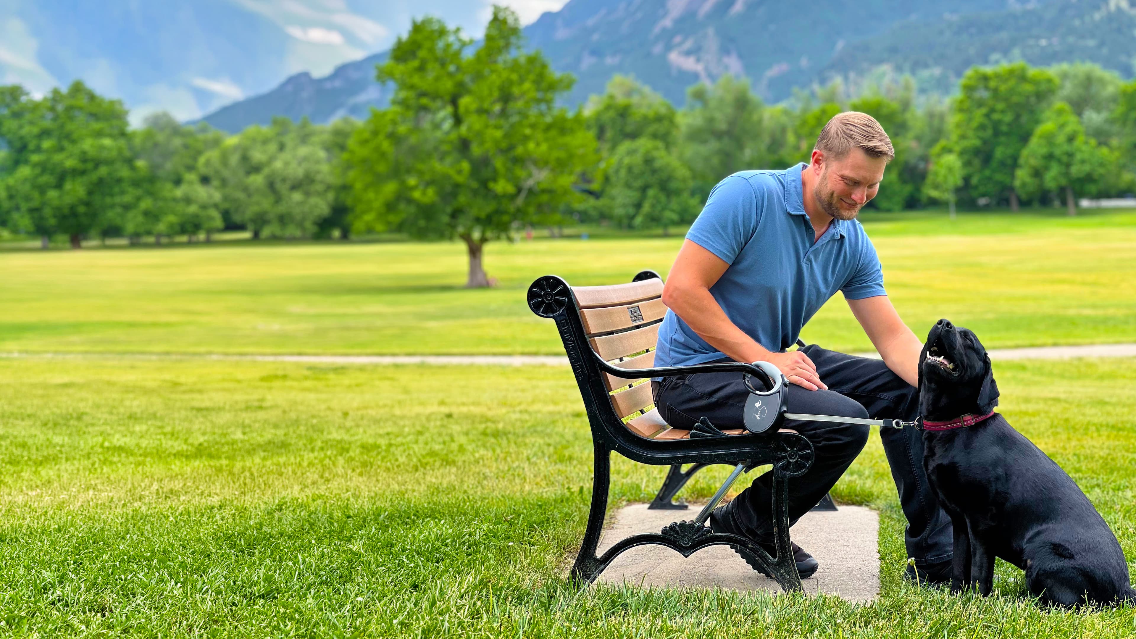 A man and his dog enjoying a hands-free walk in the park with the Snap Dog Leash retractable dog leash with clip